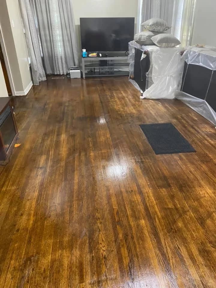 A residential living room after a Smith Girls deep clean — gleaming hardwood floor, tidy surfaces
